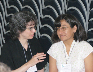 Sister Mary St. Kasai Corripio, S.N.D.deN. speaks with Sister Miriam Montero Bereche, S.N.D.deN., a sister from Peru, during a gathering of Giving Voice, www.giving-voice.org.