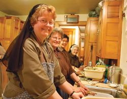 Cleaning horseradish from their community’s vegetable garden are (from left) Sister Anna Rose Kalinowski, F.S.E, Sister Suzanne Gross, F.S.E., Sister Monica Navalta, F.S.E., and Sister Mary Richards, F.S.E. 