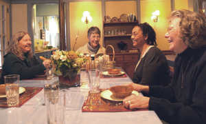 Sister nicole shares a light moment with her Marianist Sisters at a community meal. 