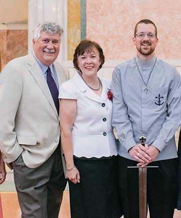 Jordan with his parents at his final vows ceremony.