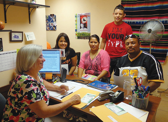 Sister Alicia Zapata, R.S.M. talks with migrant workers in Central Florida.