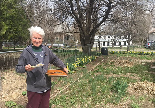 Sister Imelda Schmidt, O.P. brings homemade apple bread to students in a permaculture certification course held at Heartland Farm.