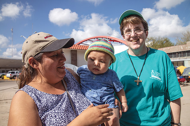 Many sisters do not wear a habit but do wear a religious symbol, such as the cross worn here by Sister Jennifer Pierce, SNDdeN (right).