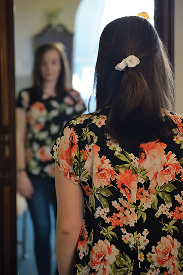 Young woman looks at her reflection