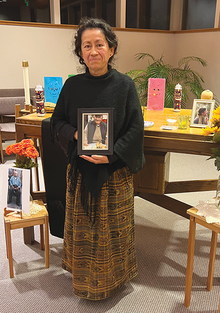 Sister Paz Vital, O.S.B. before her community’s Day of the Dead altar.