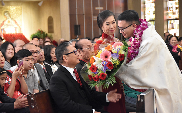 Father Henry Nguyen, S.C.J. with his parents during his ordination Mass. 