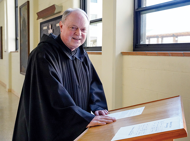 Brother Charles Manning, O.S.B. (at left) wears the cuculla, the garment of a monk in solemn vows. 