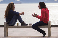 two young women talking on bench