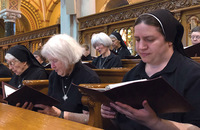  Sister Maria Victoria Cutaia, O.S.B. (far right), prays with her sisters. 