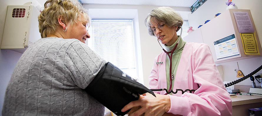 Sister Carole Blazina, S.C. performs a blood pressure check. 