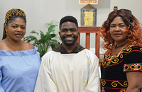 Rigobel Azanwi, O.F.M.Cap. takes a moment with family members after his solemn vows ceremony.