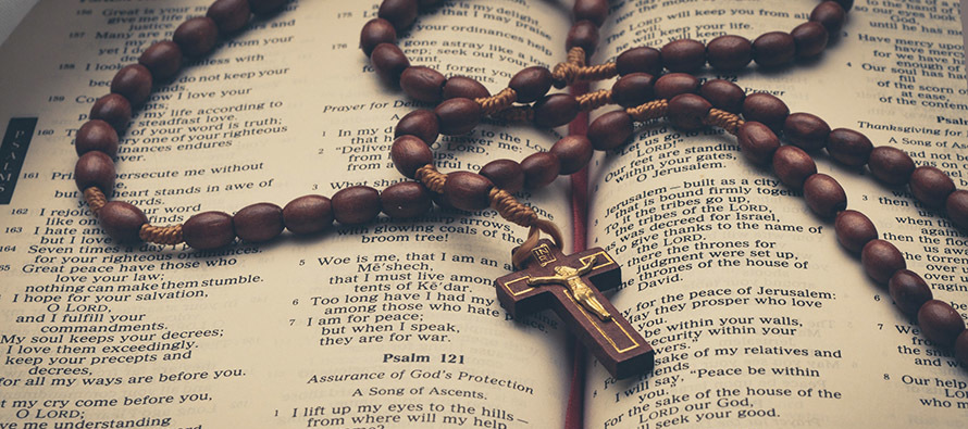 Rosary beads on an open Bible