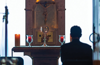 Man praying before a church altar