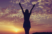 Young woman looking at the sunset