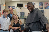 Brother Antonio Moualeu, O.F.M.Conv. gives a science lab demonstration to a family attending a St. Francis High School open house.